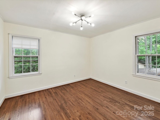 1049 Regency Dr, Charlotte, NC 28211 - empty room featuring a chandelier, dark wood finished floors, and baseboards