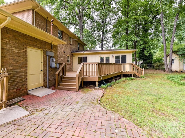 1049 Regency Dr, Charlotte, NC 28211 - back of property featuring brick siding, a wooden deck, a yard, a patio, and an outbuilding