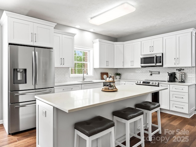 642 Bull Creek Rd, Mars Hill, NC 28754 - kitchen with appliances with stainless steel finishes, a sink, white cabinets, recessed lighting, and a textured ceiling
