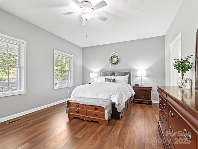 642 Bull Creek Rd, Mars Hill, NC 28754 - bedroom featuring baseboards, dark wood-type flooring, ceiling fan, and a textured ceiling
