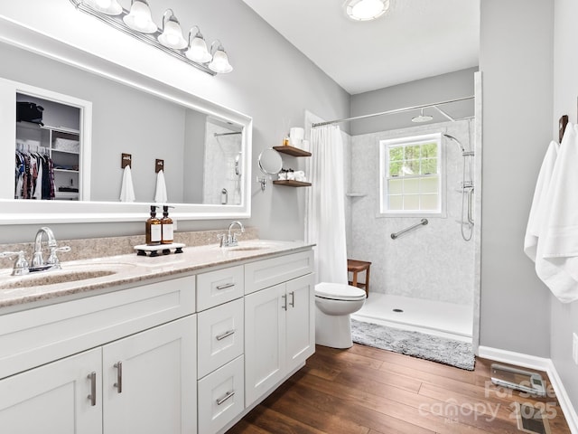 642 Bull Creek Rd, Mars Hill, NC 28754 - full bath with wood finished floors, a shower with shower curtain, double vanity, and toilet