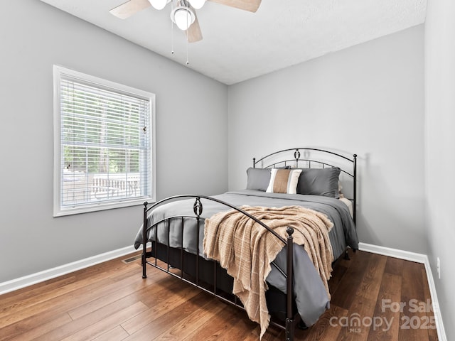 642 Bull Creek Rd, Mars Hill, NC 28754 - bedroom featuring baseboards, hardwood / wood-style flooring, and a ceiling fan