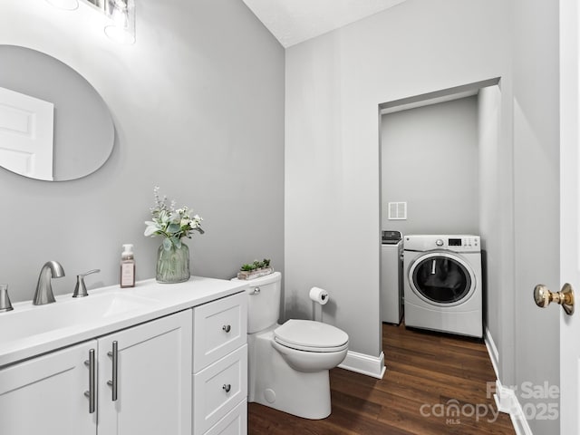 642 Bull Creek Rd, Mars Hill, NC 28754 - bathroom featuring wood finished floors, toilet, vanity, baseboards, and washing machine and clothes dryer