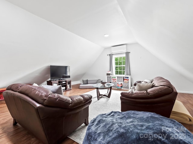 642 Bull Creek Rd, Mars Hill, NC 28754 - living room with a wall mounted air conditioner, vaulted ceiling, wood finished floors, and baseboards