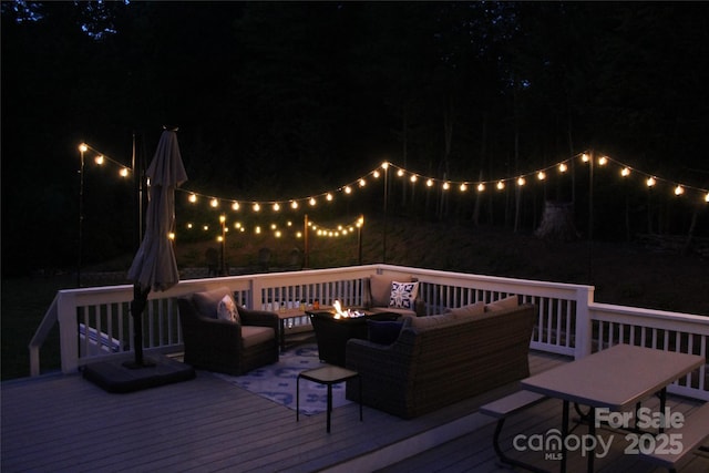 642 Bull Creek Rd, Mars Hill, NC 28754 - deck at twilight featuring an outdoor living space with a fire pit