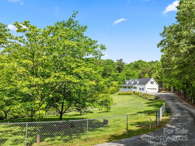 642 Bull Creek Rd, Mars Hill, NC 28754 - view of front of house featuring asphalt driveway, a garage, and a wooded view