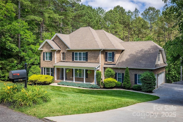 206 Ridge Top Dr, Connelly Springs, NC 28612 - view of front of house featuring brick siding, driveway, a front yard, a porch, and a shingled roof