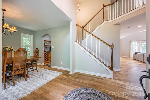 206 Ridge Top Dr, Connelly Springs, NC 28612 - dining area with stairway, wood finished floors, a chandelier, and baseboards