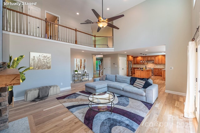 206 Ridge Top Dr, Connelly Springs, NC 28612 - living area featuring a towering ceiling, light wood-style flooring, ceiling fan, recessed lighting, and baseboards