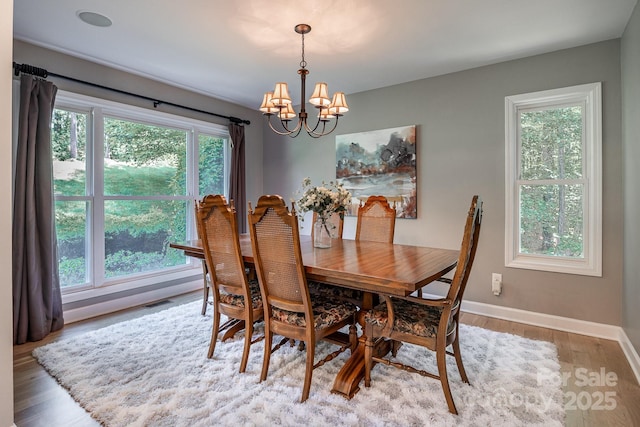 206 Ridge Top Dr, Connelly Springs, NC 28612 - dining area featuring a chandelier, baseboards, and light wood-type flooring