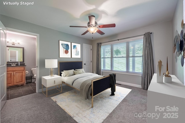 206 Ridge Top Dr, Connelly Springs, NC 28612 - bedroom featuring dark carpet, baseboards, ensuite bath, and ceiling fan