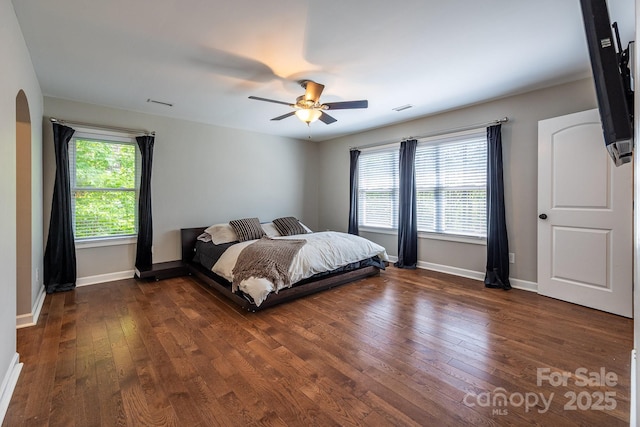 206 Ridge Top Dr, Connelly Springs, NC 28612 - bedroom featuring dark wood-style flooring, baseboards, ceiling fan, and arched walkways