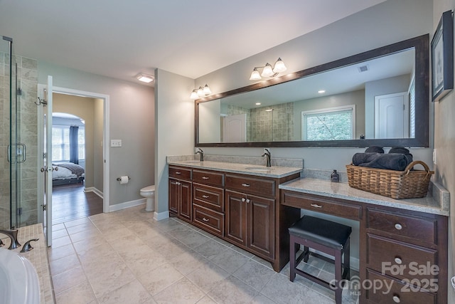 206 Ridge Top Dr, Connelly Springs, NC 28612 - ensuite bathroom featuring double vanity, toilet, a tile shower, baseboards, and tile patterned flooring