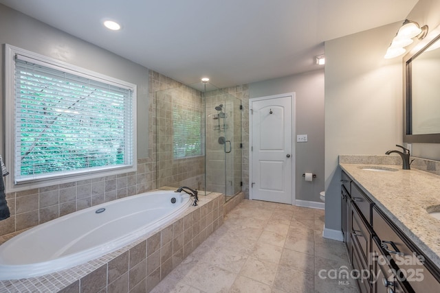 206 Ridge Top Dr, Connelly Springs, NC 28612 - bathroom featuring a garden tub, double vanity, a stall shower, baseboards, and toilet