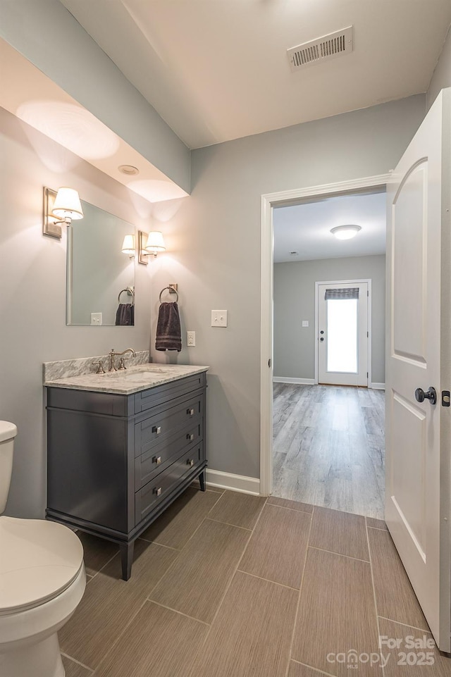 206 Ridge Top Dr, Connelly Springs, NC 28612 - bathroom featuring vanity, wood finished floors, toilet, and baseboards