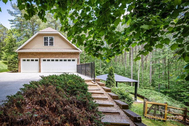 206 Ridge Top Dr, Connelly Springs, NC 28612 - view of side of property featuring a garage, brick siding, and an outdoor structure