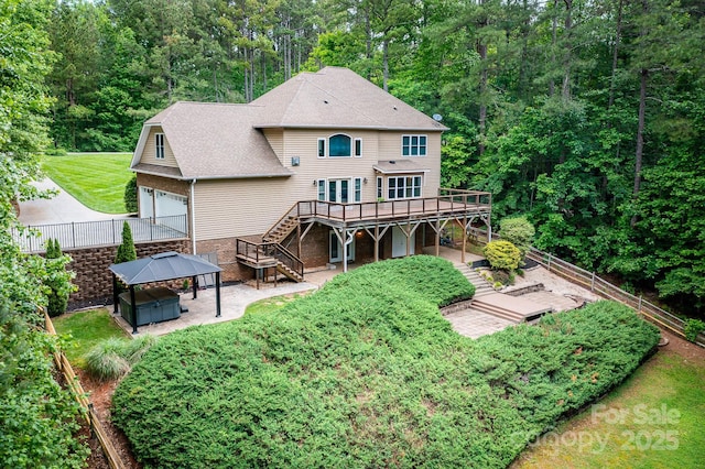 206 Ridge Top Dr, Connelly Springs, NC 28612 - back of house with stairway, a covered hot tub, a wooden deck, a garage, and a shingled roof