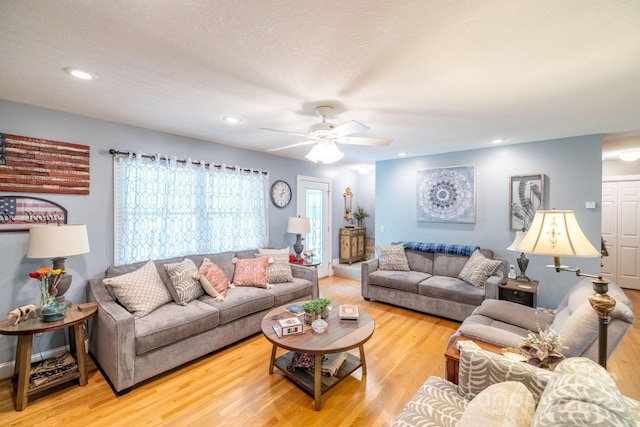 living area with wood finished floors, a ceiling fan, and recessed lighting