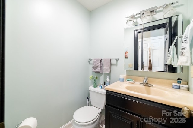 half bath featuring toilet and vanity