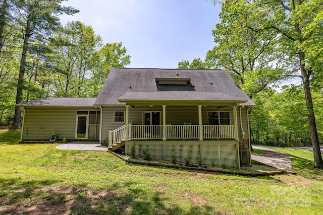 back of property featuring a lawn and a porch