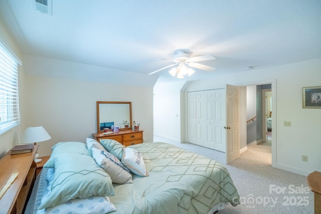 bedroom with a closet, a ceiling fan, carpet floors, and baseboards