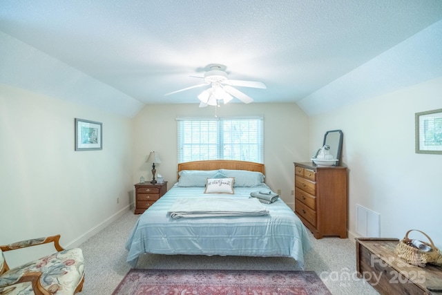 carpeted bedroom with lofted ceiling, a ceiling fan, and baseboards