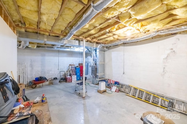 unfinished basement featuring heating unit