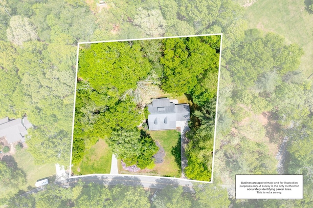 view of property location featuring property parcel outlined and a heavily wooded area