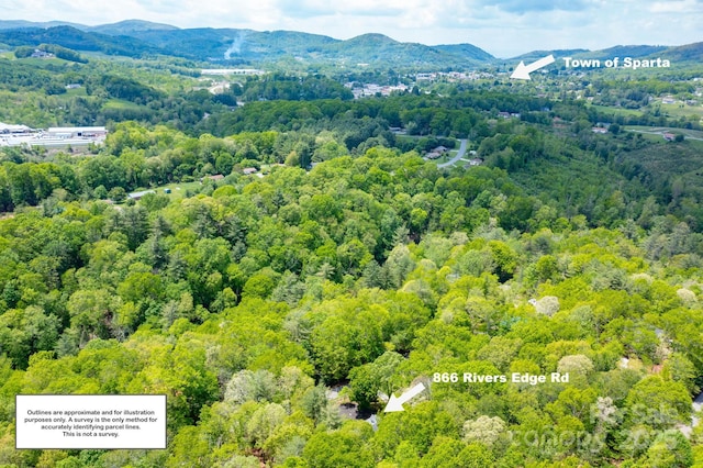 bird's eye view of a heavily wooded area and mountains