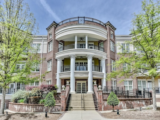 5425 Closeburn Rd, Charlotte, NC 28210 - view of front facade with a balcony, stairs, and brick siding
