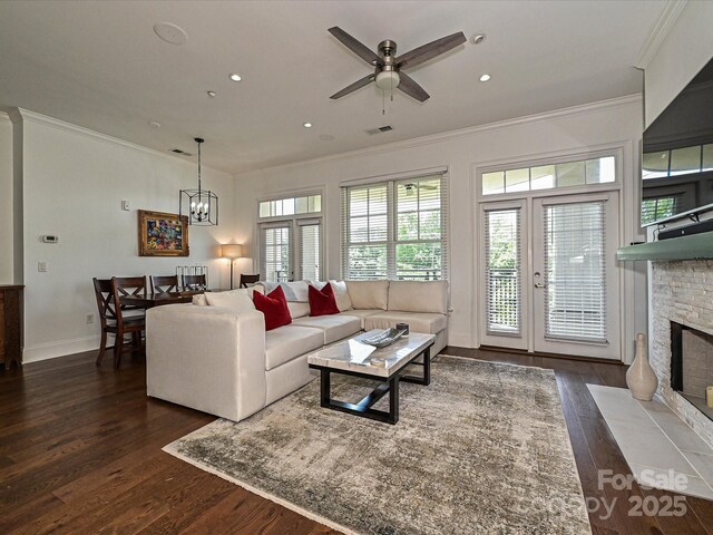 5425 Closeburn Rd, Charlotte, NC 28210 - living room with crown molding, a stone fireplace, wood finished floors, a ceiling fan, and baseboards