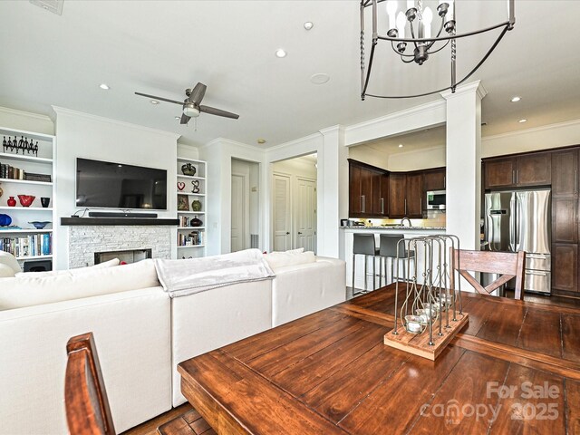 5425 Closeburn Rd, Charlotte, NC 28210 - living area with ceiling fan, ornamental molding, recessed lighting, a stone fireplace, and a chandelier