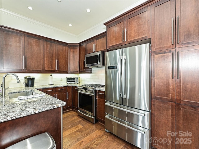 5425 Closeburn Rd, Charlotte, NC 28210 - kitchen with appliances with stainless steel finishes, light stone counters, crown molding, dark wood finished floors, and a sink