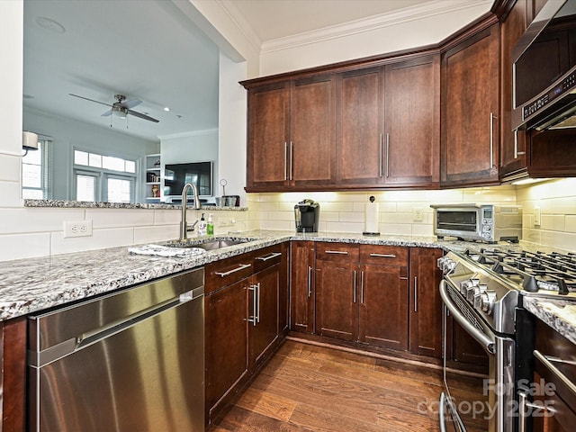 5425 Closeburn Rd, Charlotte, NC 28210 - kitchen featuring appliances with stainless steel finishes, a sink, light stone countertops, a ceiling fan, and dark wood-style flooring