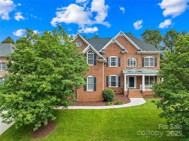 10024 Hazelview Dr, Charlotte, NC 28277 - colonial home featuring brick siding, a front yard, and a porch