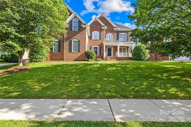 10024 Hazelview Dr, Charlotte, NC 28277 - colonial-style house featuring brick siding, a front yard, and covered porch