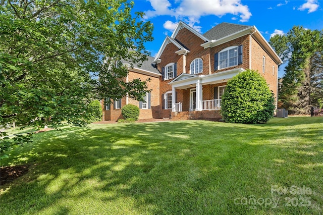 10024 Hazelview Dr, Charlotte, NC 28277 - view of front of home featuring brick siding, covered porch, a front yard, and central air condition unit