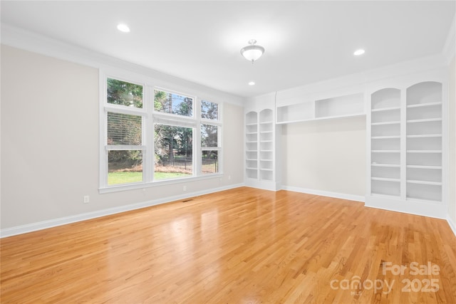 10024 Hazelview Dr, Charlotte, NC 28277 - spare room featuring crown molding, light wood-type flooring, built in shelves, baseboards, and recessed lighting