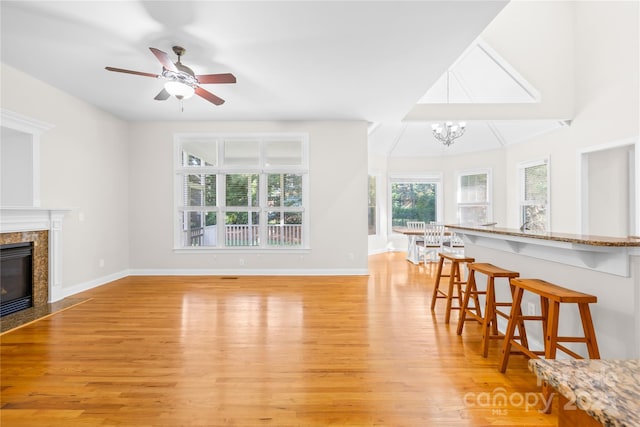 10024 Hazelview Dr, Charlotte, NC 28277 - living area with light wood-style floors, a premium fireplace, a chandelier, and baseboards