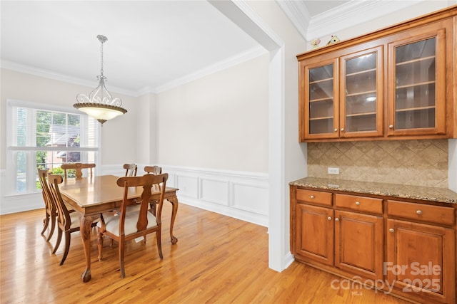 10024 Hazelview Dr, Charlotte, NC 28277 - dining space featuring ornamental molding, light wood finished floors, and wainscoting