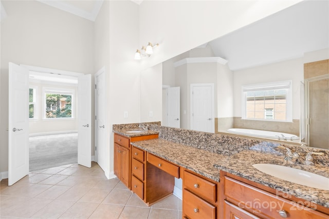 10024 Hazelview Dr, Charlotte, NC 28277 - full bath featuring tile patterned flooring, a shower stall, a garden tub, high vaulted ceiling, and double vanity