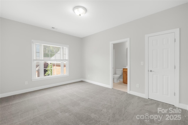 10024 Hazelview Dr, Charlotte, NC 28277 - unfurnished bedroom with light colored carpet, baseboards, and connected bathroom