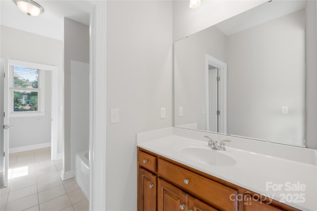10024 Hazelview Dr, Charlotte, NC 28277 - bathroom featuring tile patterned flooring, vanity, a tub to relax in, and baseboards
