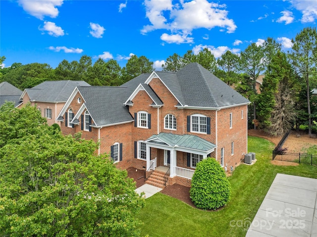 10024 Hazelview Dr, Charlotte, NC 28277 - colonial home featuring covered porch, brick siding, central air condition unit, and a shingled roof