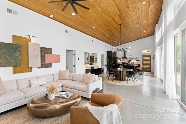 7 Big Rocky Top Dr, Weaverville, NC 28787 - living area with wood ceiling, high vaulted ceiling, finished concrete floors, a chandelier, and a ceiling fan