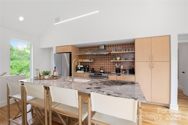 7 Big Rocky Top Dr, Weaverville, NC 28787 - kitchen featuring stainless steel appliances, wall chimney range hood, backsplash, light wood finished floors, and vaulted ceiling
