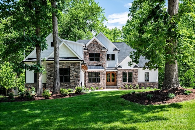 7703 Juniper Ln, Denver, NC 28037 - craftsman-style home featuring stone siding, french doors, and a front lawn