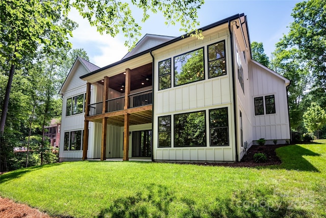7703 Juniper Ln, Denver, NC 28037 - back of property with board and batten siding, ceiling fan, and a lawn