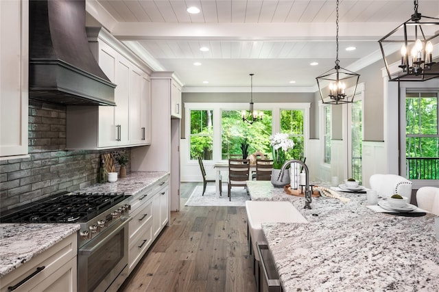 7703 Juniper Ln, Denver, NC 28037 - kitchen with stainless steel range, premium range hood, a chandelier, wood-type flooring, and a sink