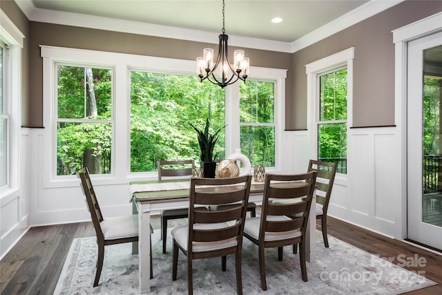 7703 Juniper Ln, Denver, NC 28037 - dining room with a decorative wall, a chandelier, a wainscoted wall, dark wood-style flooring, and crown molding